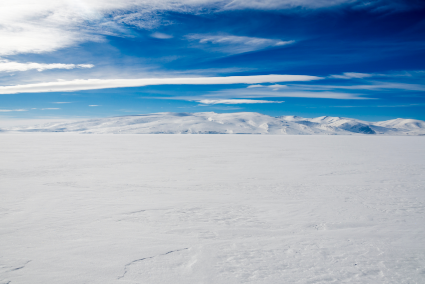 View of a frozen lake stretching into the horizon.
